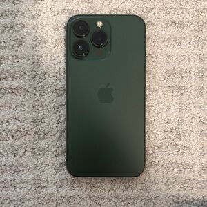 Apple iPhone 13 pro in Forest Green with pink apple case.